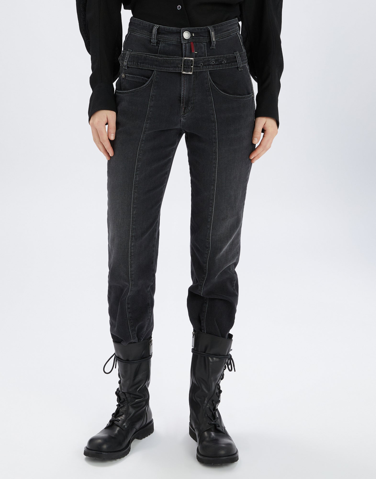 Front view: FAIR-PLAY black slim-fit jeans with removable double belt at the hips, visible seams, and trendy used look, styled with tall black boots.