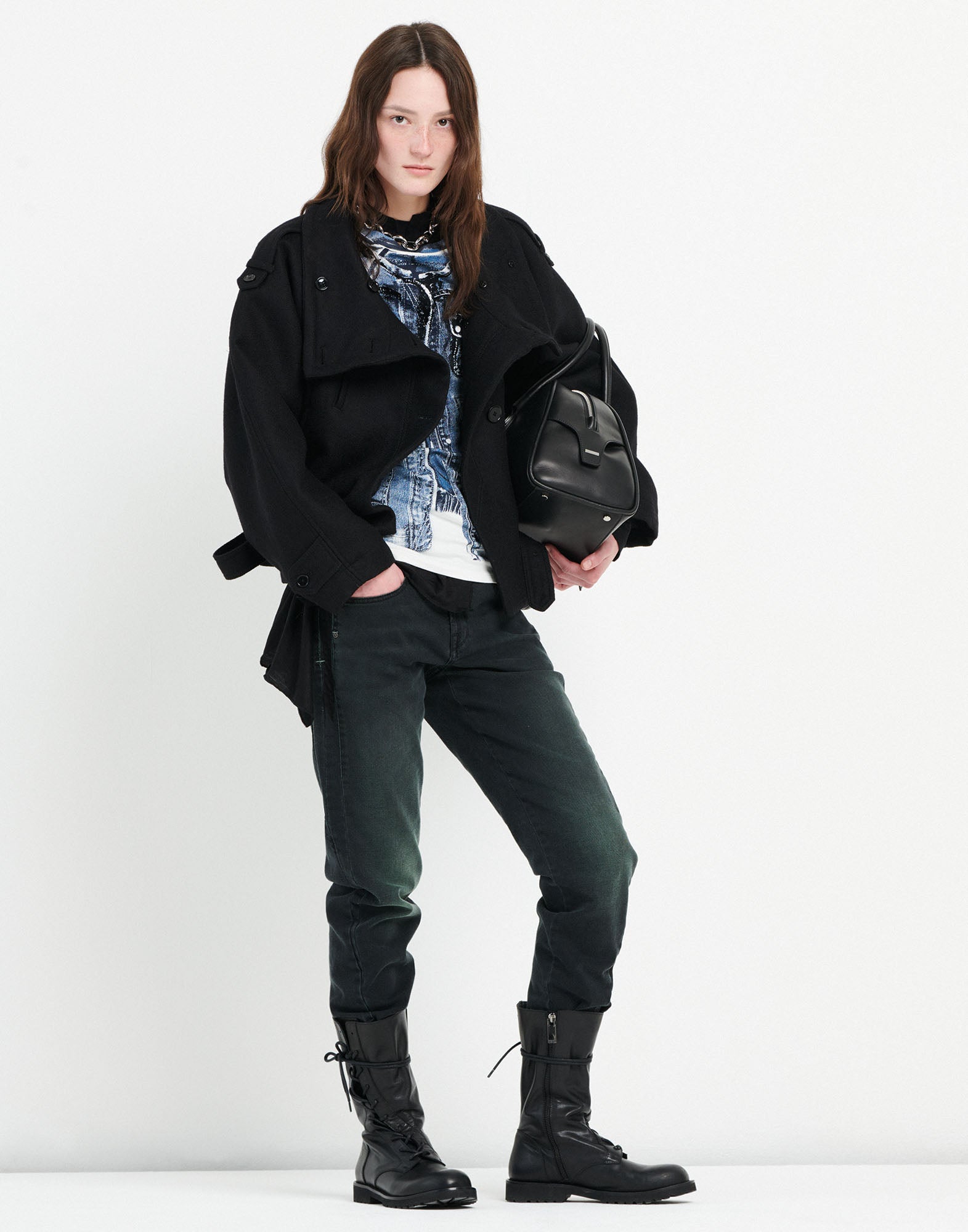 Front view of a person in HAPPLY jeans with darker panels, visible seams, side and back pockets, paired with black boots and a jacket.
