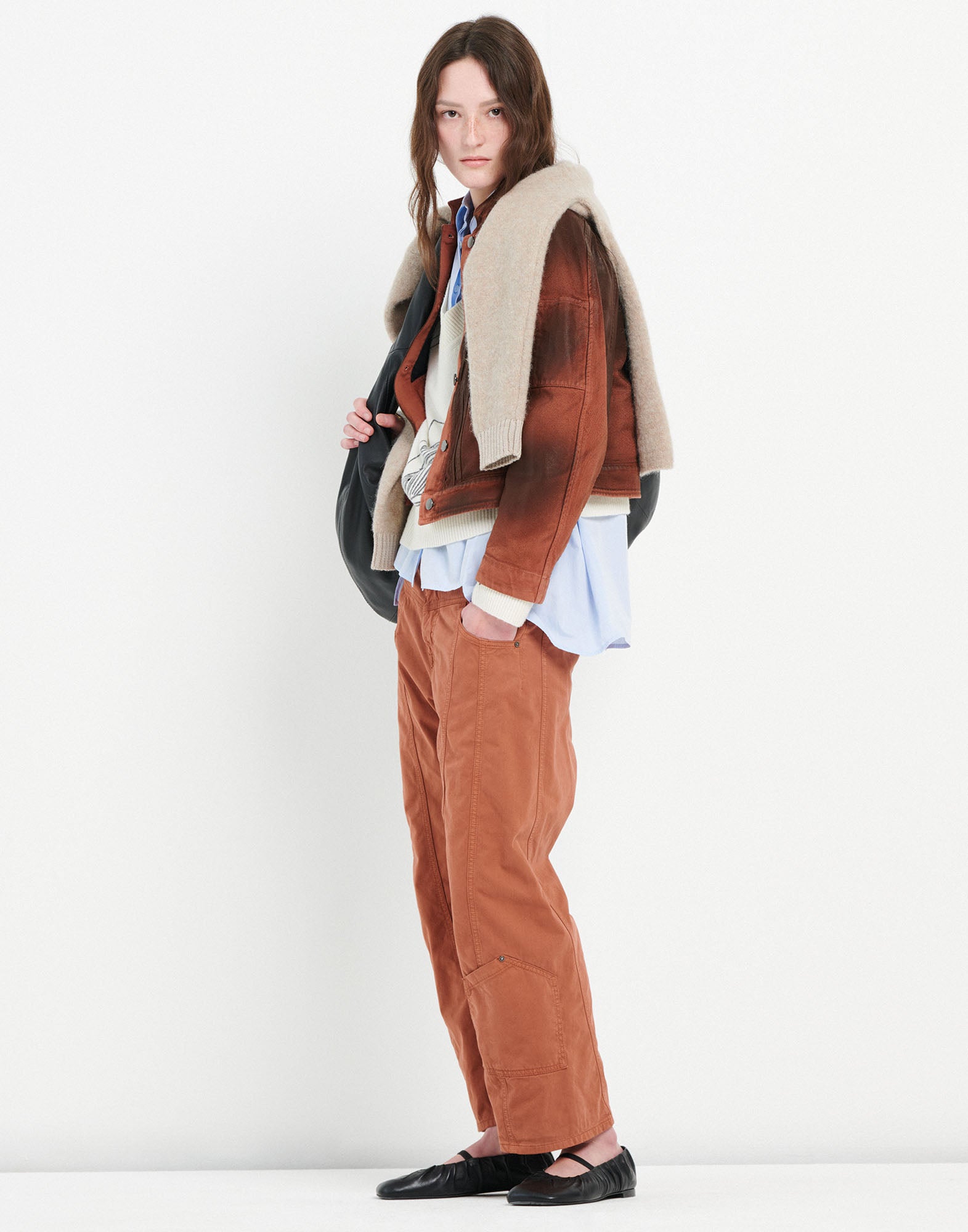 Frontalansicht einer Frau, die die TENDRIL Denimjacke im Workwear-Stil trägt, mit kurzer Boxy-Silhouette, sichtbaren Nähten und lederähnlichem Finish.