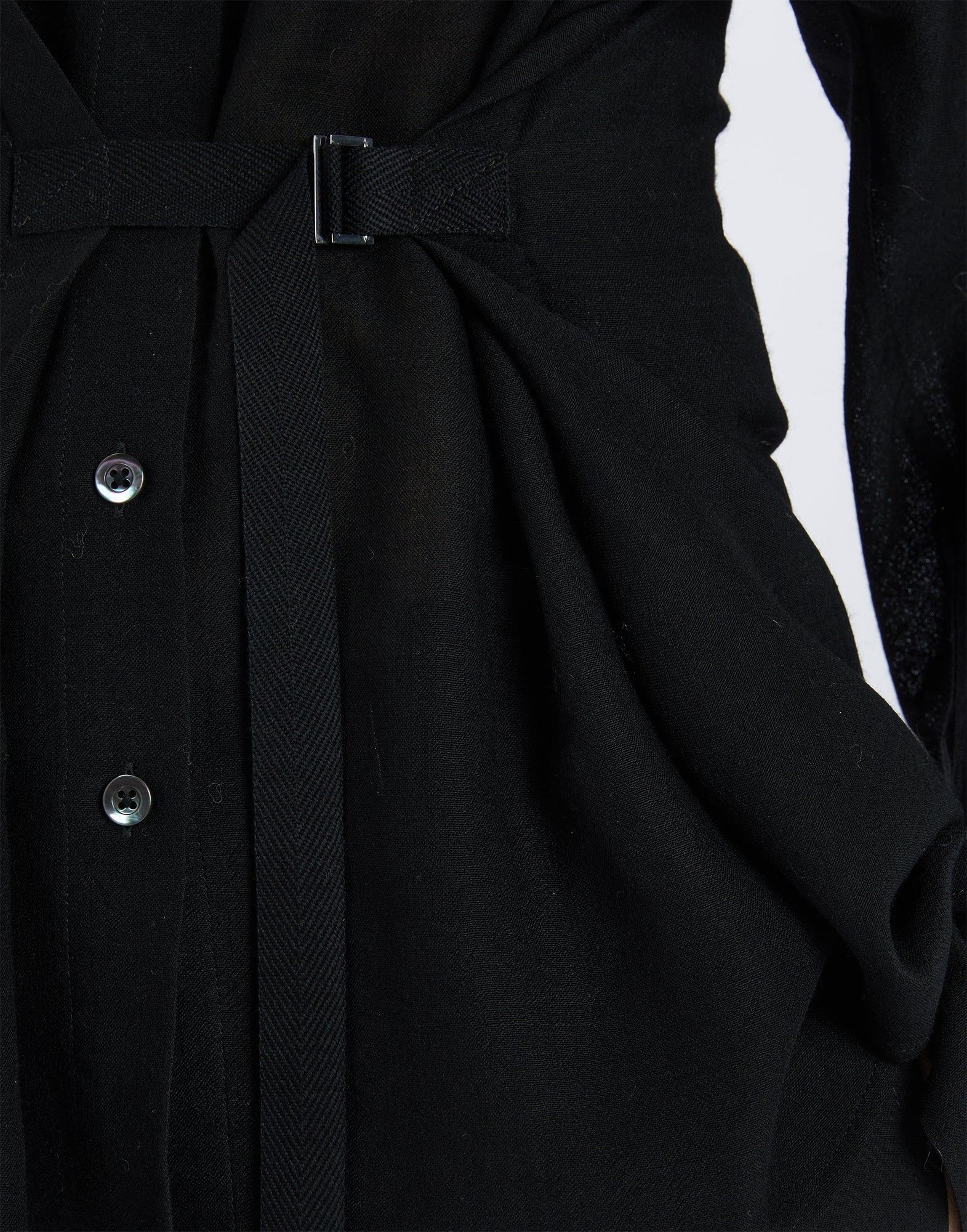 Close-up view of SCOOT, shows front button placket, black fabric belt with D-ring, and extra-fine black wool gauze, delicate fabric.