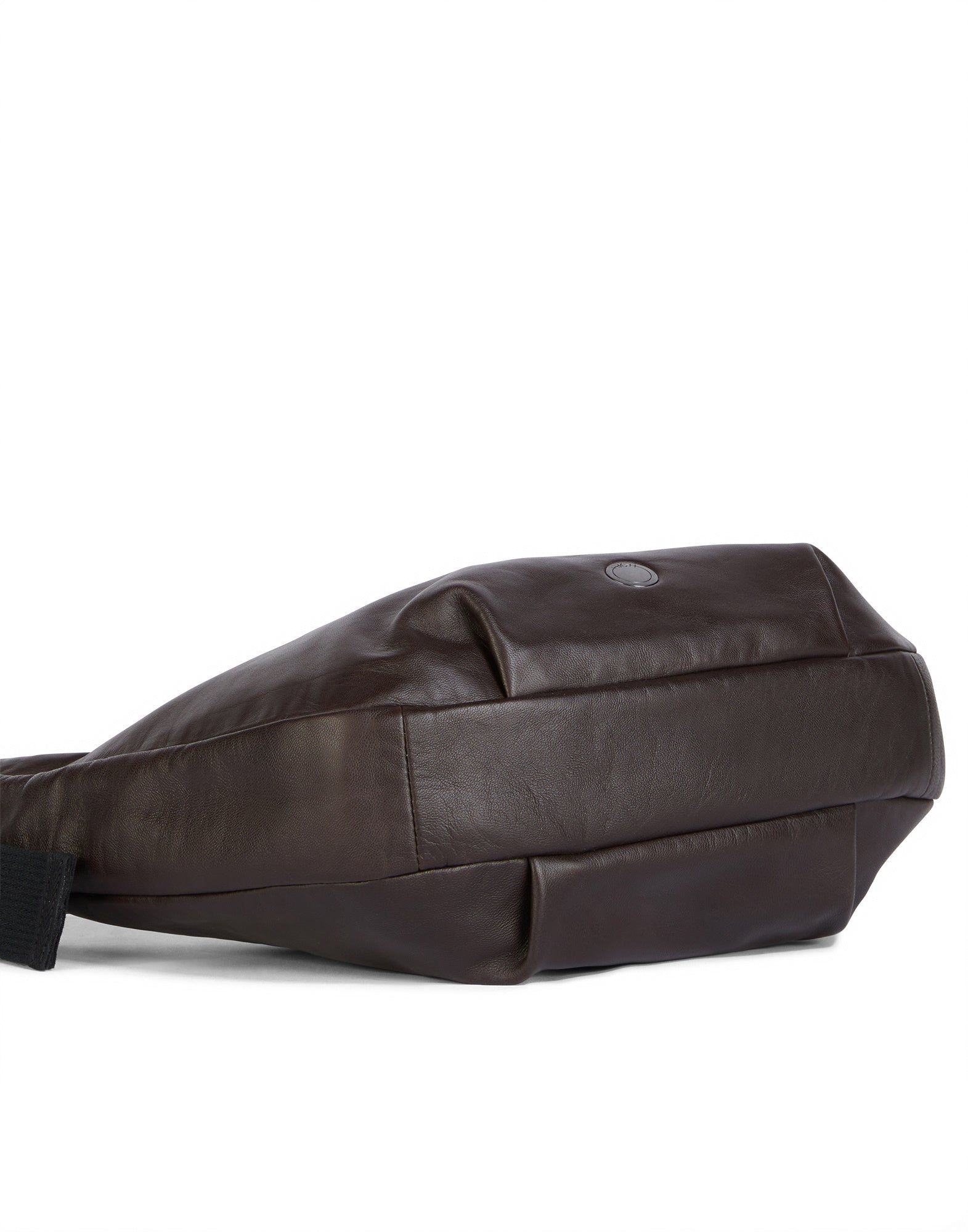 Side view of ADMIRAL crossbody bag in dark brown lamb leather, lying flat, with removable wallet and subtle logo embossing on cotton lining.