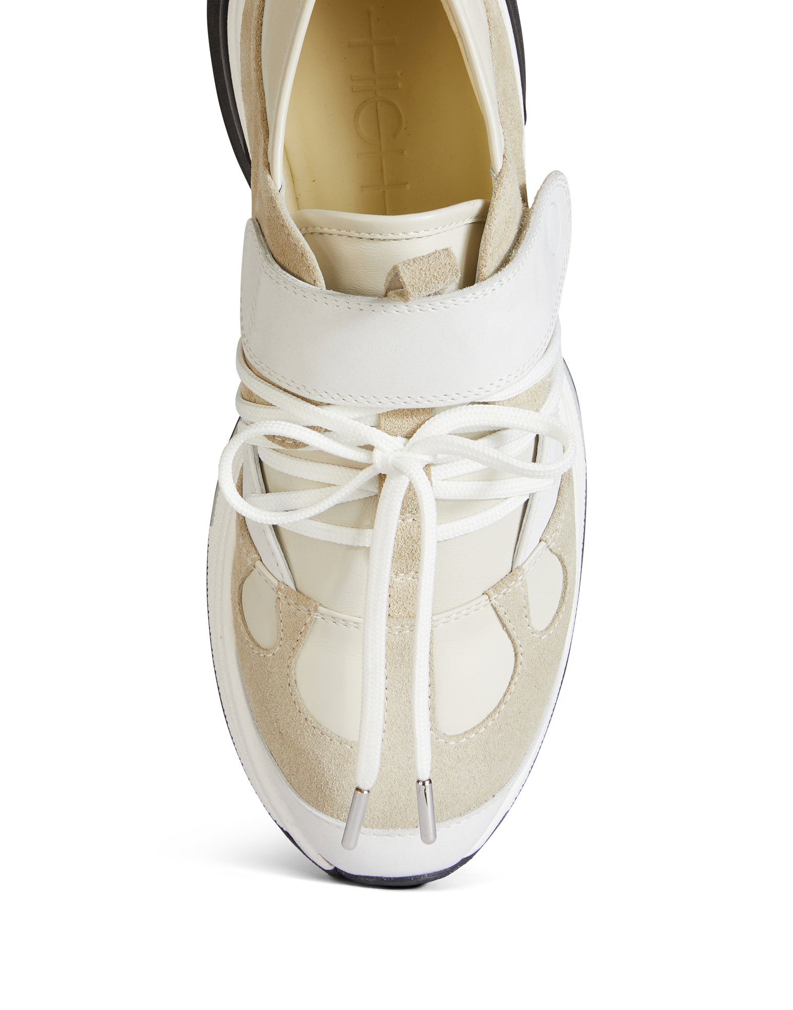 Detail view, top perspective: Sneaker PARTIAL with tonal leathers, lace-up closure, Velcro strap, color-block sole. Logo visible on tongue.