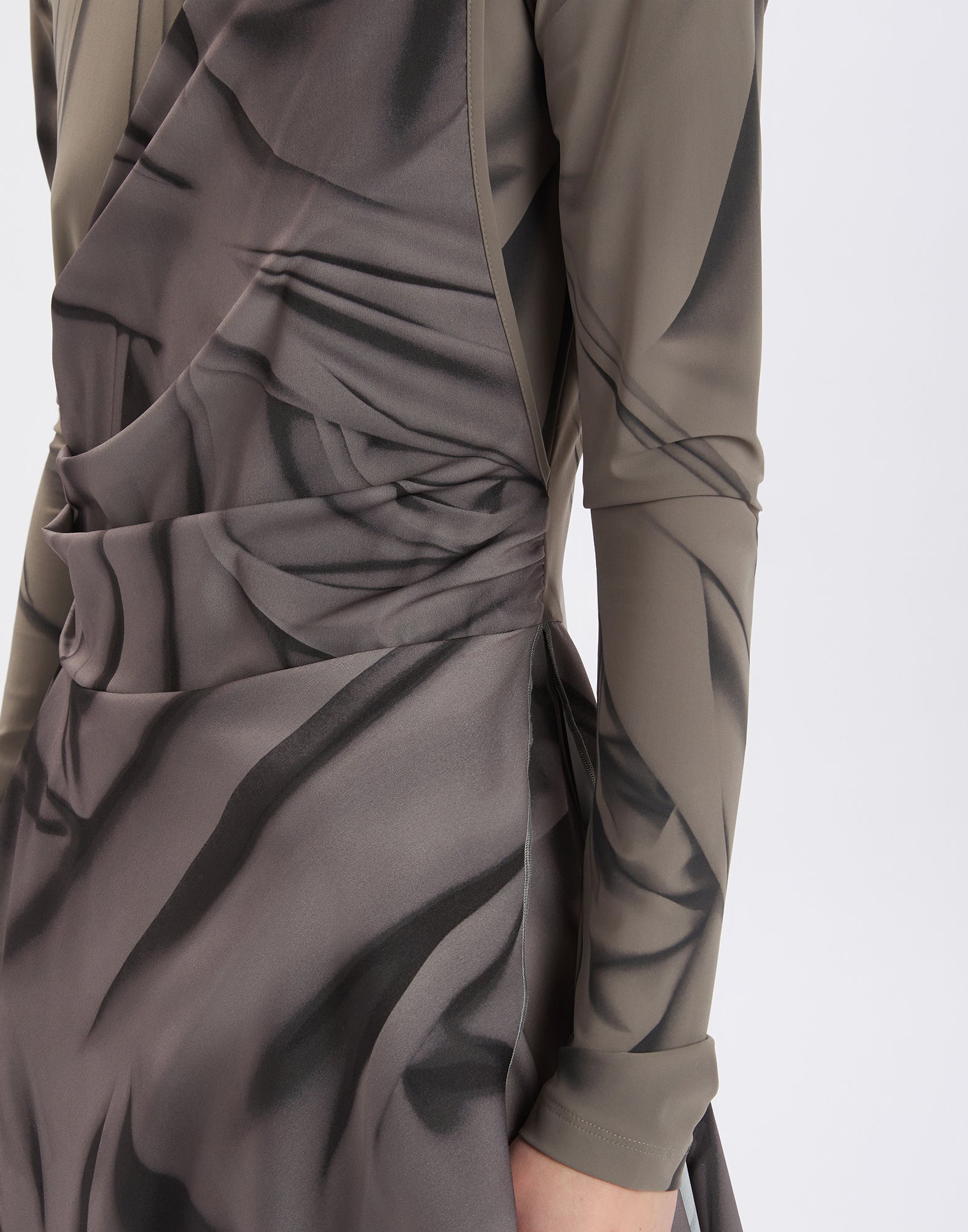 Detail view of TROUPE dress, showing the side section and sleeve. Visible are the printed technical crepe de chine fabric and the Drapery motif.