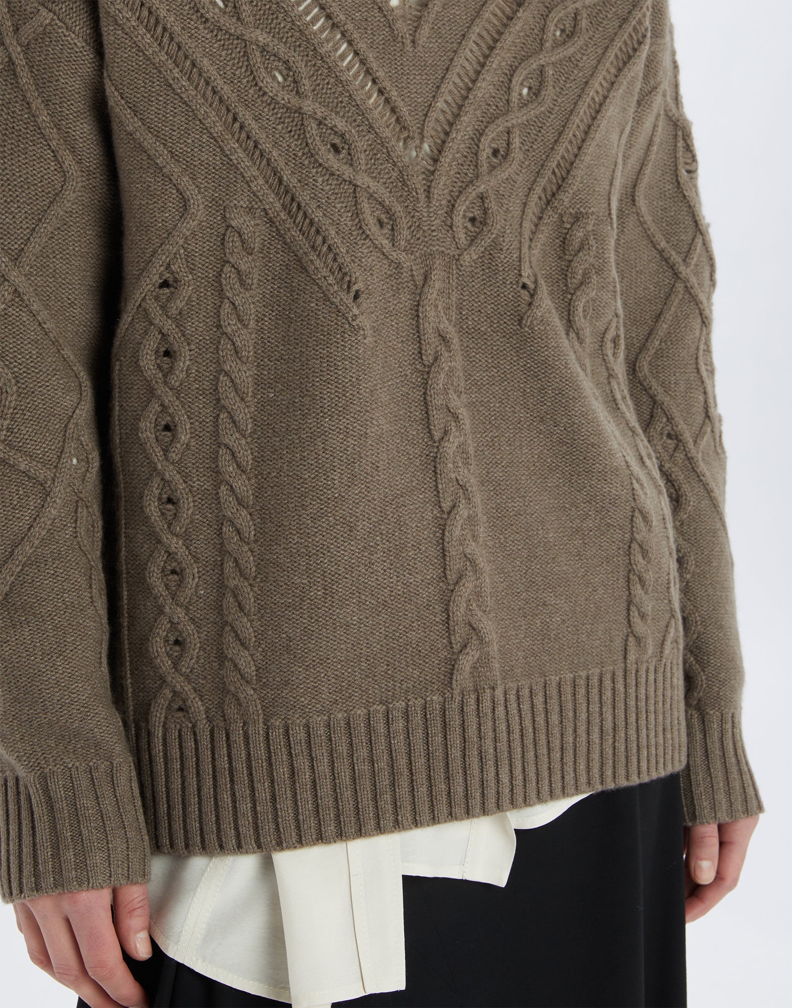 Front view of the NORTON sweater in wool and cashmere, featuring wide ribs, cable and openwork patterns, ribbed hem and V-neck, worn on model.