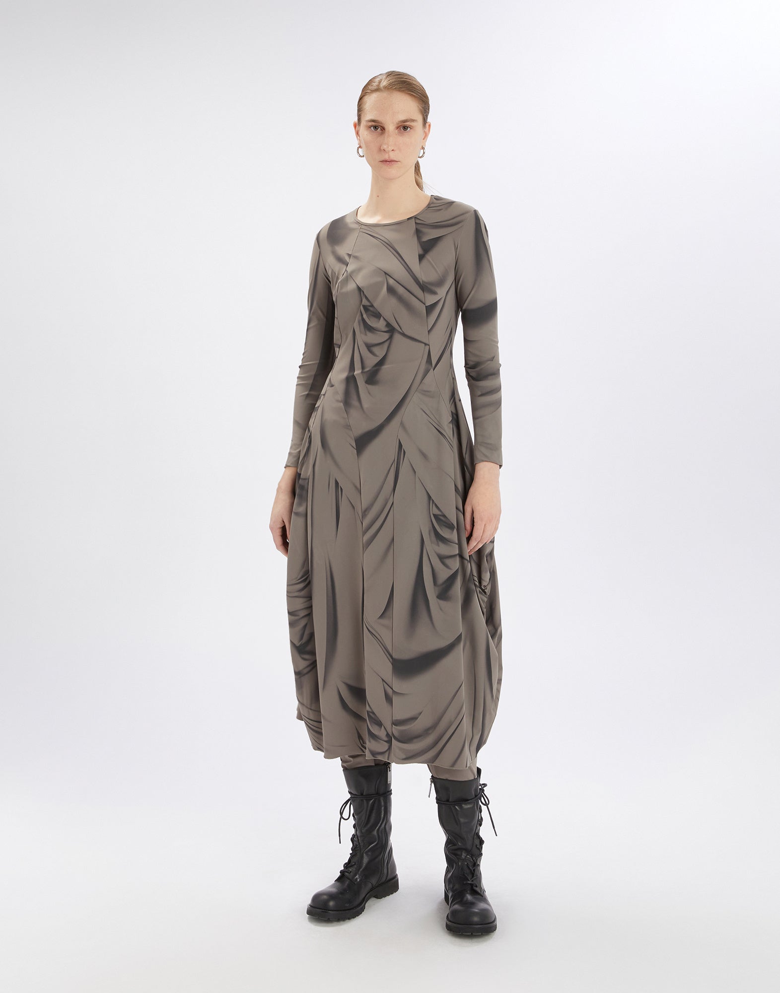 Front view of a person wearing the AT-LENGTH dress. The dress features an artistic Drapery print, long balloon skirt, long sleeves, and wide pleats.