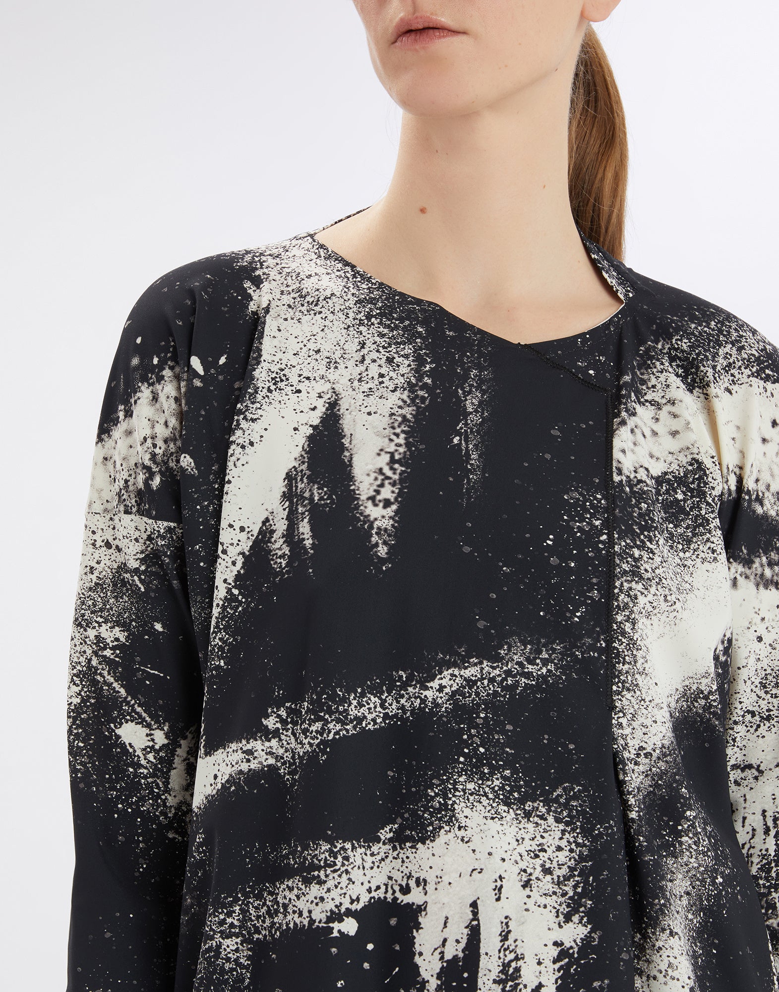 Front view shows the PRELUDE dress with black and white spray-effect print, decorative seams, and asymmetric neckline.